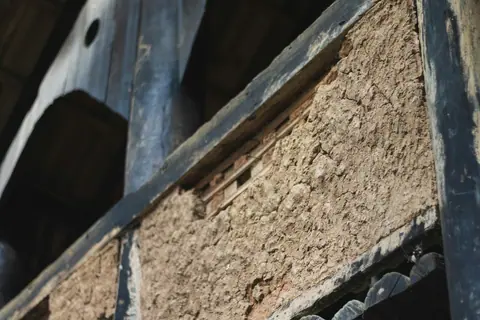 Insulation material in a wall cavity